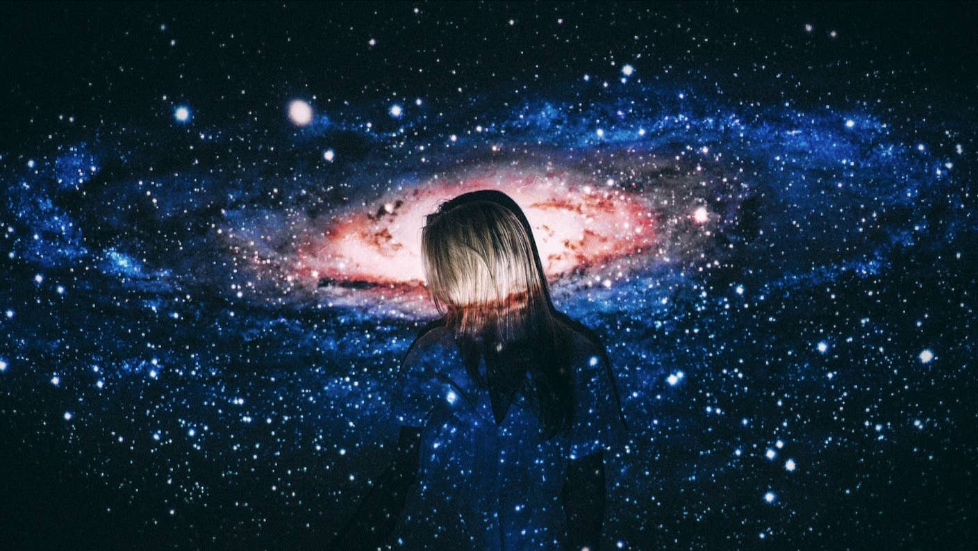 How Does Consciousness Work? Dueling Scientists Tested Two Big Theories but Found No Winner A woman standing amid a galactic swirl of stars